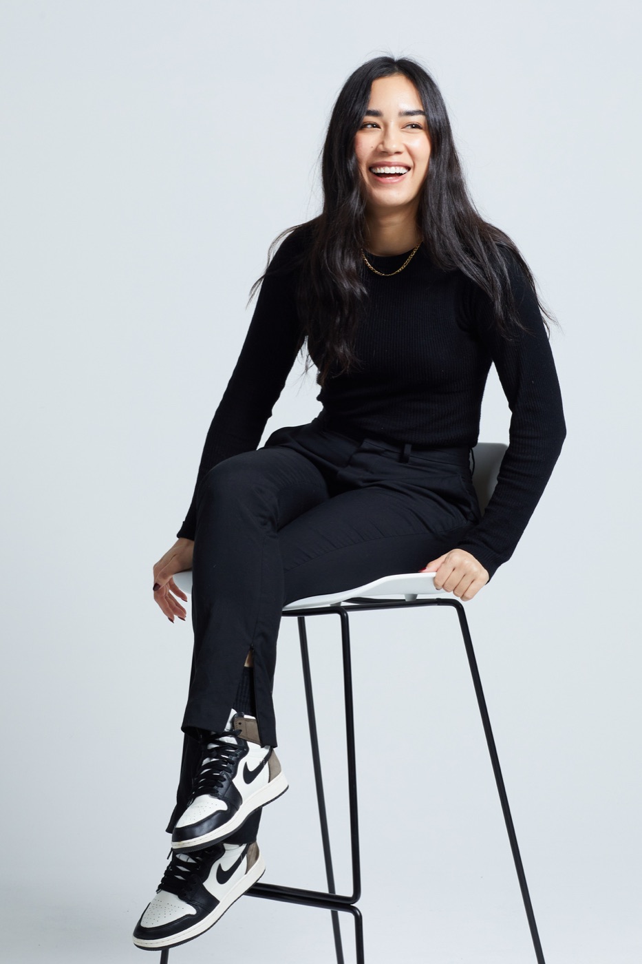 Christina Lawson laughing, sitting on a stool