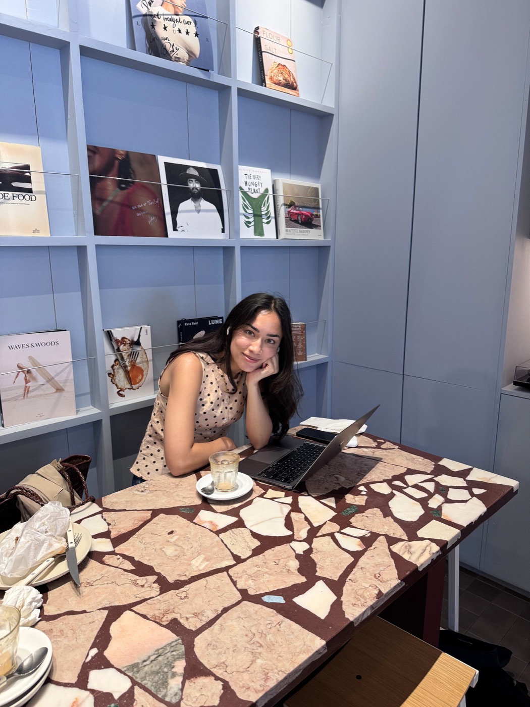 Christina working on a laptop in a Lisbon café